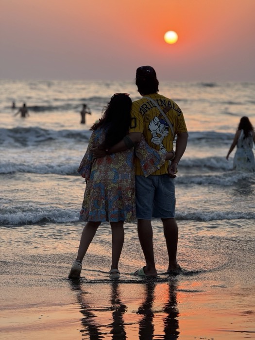Archana and DP watching the sunset at the beach